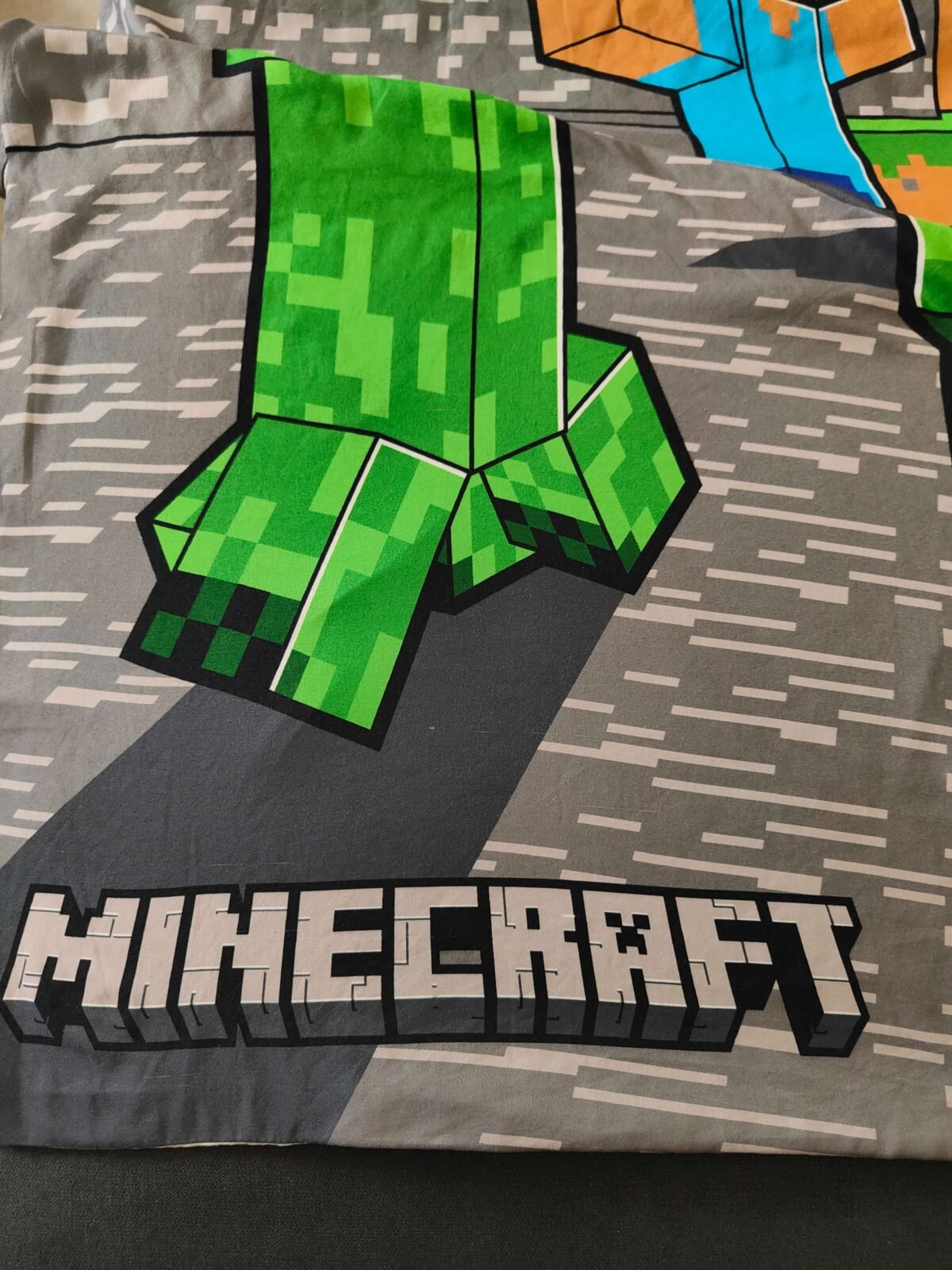 détail état housse Minecraft occasion traces usage visibles